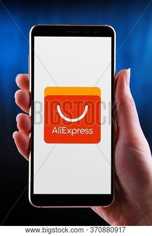 Hands Holding Smartphone Displaying Logo Of Aliexpress