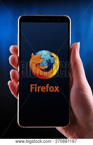 Hands Holding Smartphone Displaying Logo Of Firefox