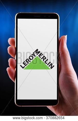 Poznan, Pol - May 21, 2020: Hands Holding Smartphone Displaying Logo Of Leroy Merlin, A Home Improve