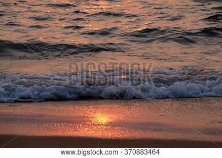 CANDOLIM, INDIA - FEBRUARY 18, 2020: Wave rolling over the sands on Candolim Beach, North Goa, India