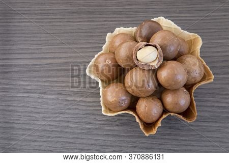 Macadamia Nuts - Macadamia Integrifolia. Wood Background