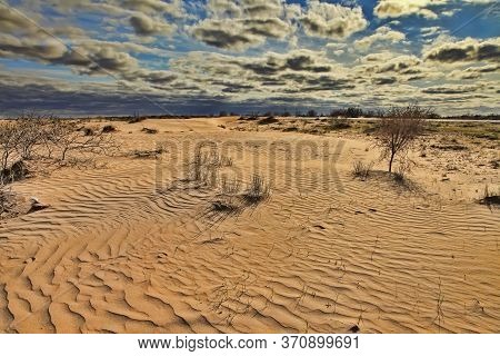 Karakum Desert At Sunset. Road Crossing The Karakum Desert In Turkmenistan.