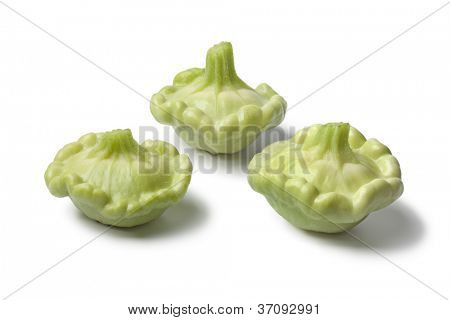 เด็ก Pattypan squashes บนพื้นหลังสีขาว
