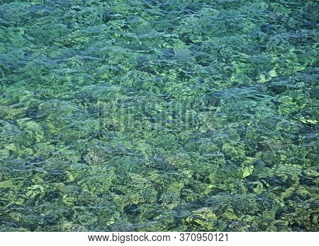 Turquoise Colored Rocks Visible Through Clean And Transparent Sea Water