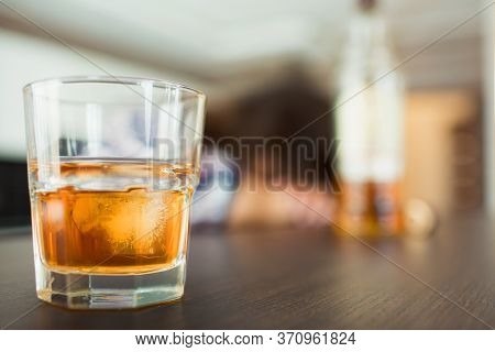 Young Woman In Kitchen During Quarantin. Glass With Whiskey Or Another Alcohol Drink In Front. Slepp