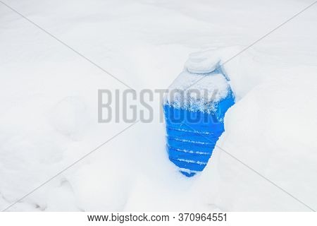 Non-freezing Liquid For Washing Car Glass In Winter. Car Non-freezing Fluid In Frost On Snow. Blue L