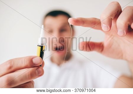 Young Man Isolated Over White Background. Guy Hold Instant Glue In Hand And Touching It. Scream And 