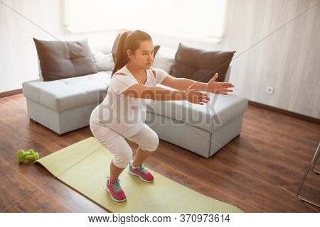 A Pregnant Woman Works Out On A Yoga Mat At Home. Pregnancy And Sports. Oga And Pilates For Pregnant