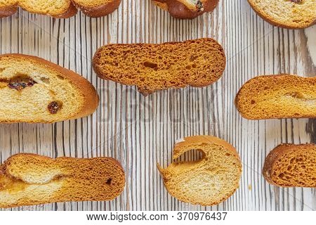 Wheat Rusks On A Wooden Background. Background From Rusks. Photographed Close-up.