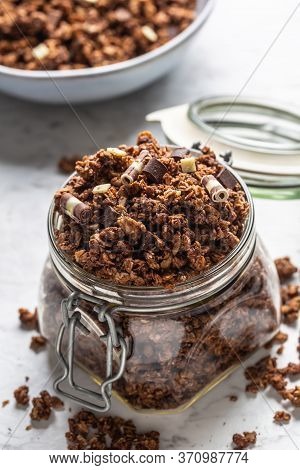 Jar Of Muesli With Dark And Milk Cocolate Pieces - Closeup.