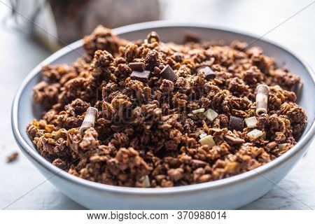 Bowl Of Muesli With Dark And Milk Cocolate Pieces - Closeup.