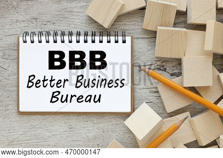 Concept Of Bbb - Better Business Bureau. Text On White Notepad Paper Near Cubes.