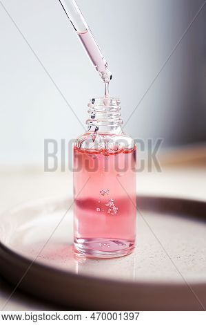 Pipette And Transparent Bottle With Serum, Gel, Oil Or Other Cosmetic Product. Trendy Selfcare Beaut