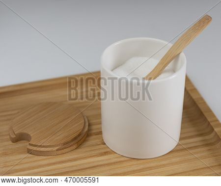 Kitchen Jar With White Sugar. Wooden Spoon And Stand. Sweet Ingredient For Dessert. Closeup Photo