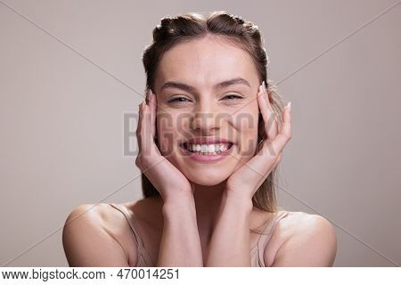 Happy Smiling Woman Wearing Natural Make Up Holding Hands On Face Portrait. Attractive Model With Po