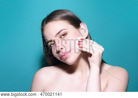 Woman Cleaning Face With A Cotton Pad. Skincare, Cotton Pad And Woman Cleaning Face On Studio Backgr