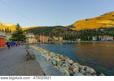 Nago-torbole, Italy - February 26, 2022: View Of The North Shore Of Lake Garda, With Locals And Visi