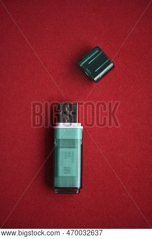 Usb Flash Drive Close-up On A Red Background. One Usb Flash Drive With A Lid.