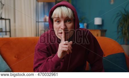 Shh Be Quiet, Hush Please. Young Woman With Short Blonde Hair Presses Index Finger To Lips Makes Sil