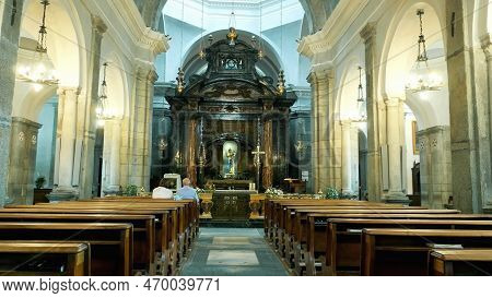 Oropa, Biella, Italy - July 7, 2018: People Sit On The Benches, At The Altar, In The Catholic Church