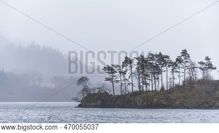 Beautiful Calm Peaceful Winter Landscape Over Thirlmere In Lake District With Fog And Layers Of Tree