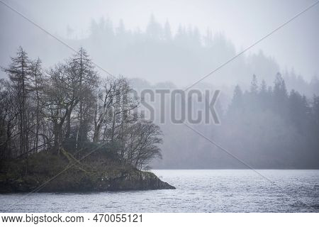 Beautiful Calm Peaceful Winter Landscape Over Thirlmere In Lake District With Fog And Layers Of Tree