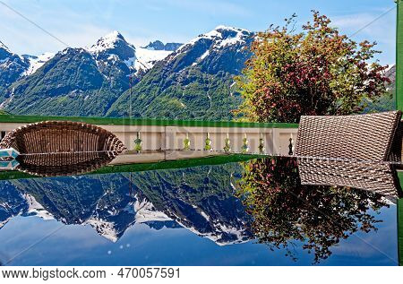 Travel Destination - Reflexion In A Glass Table Of Beautiful Landscape With Mountains Near Hellesylt