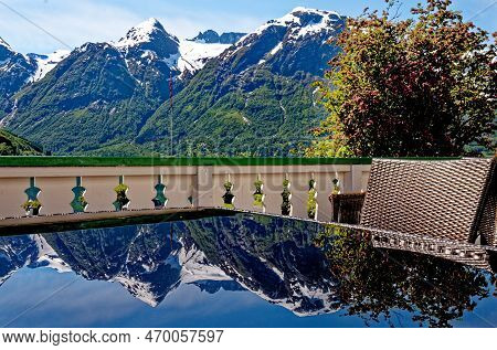Travel Destination - Reflexion In A Glass Table Of Beautiful Landscape With Mountains Near Hellesylt