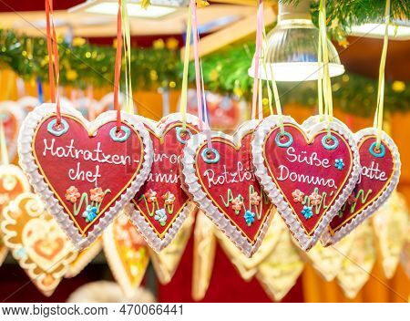 Several Austrian Heart-shaped Christmas Gingerbread Hanging In A Display Case.