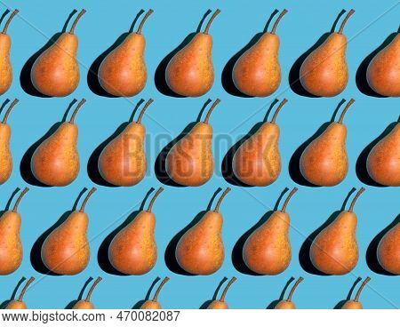 Colorful Pear Pattern. Yellow And Orange Bera Pears On A Blue Background. Ripe Juicy Fruits Top View