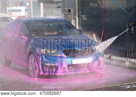 Process Of Man Washing His Car In A Self-service Car Wash Station