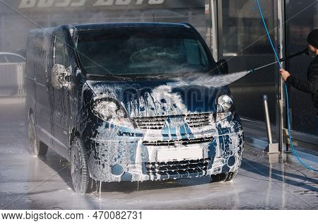 Process Of Man Washing His Car In A Self-service Car Wash Station