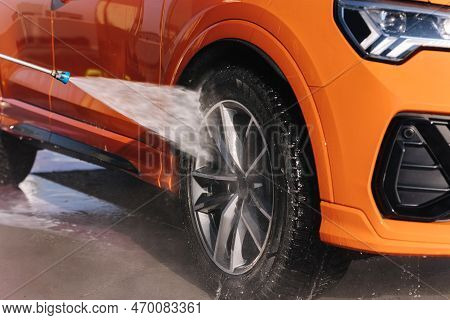 Close-up Of Washing Wheels Using A Jet Sprayer