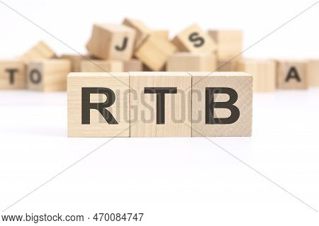 Text Rtb - Real Time Bidding - Is Written On Three Wooden Cubes Standing On A White Table. In The Ba