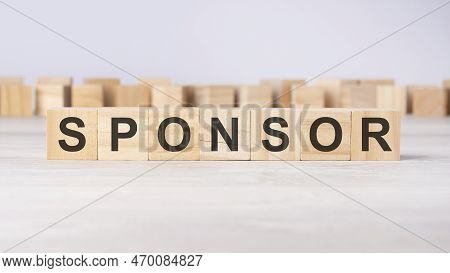 Word Sponsor Inscribed On Wooden Cubes Lying On A Light Table. Economy And Investments Concept.