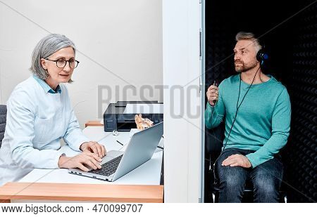 Male Patient Sitting In Audiology Booth Receives Hearing Exam And Audiometry With Ent Doctor At Audi