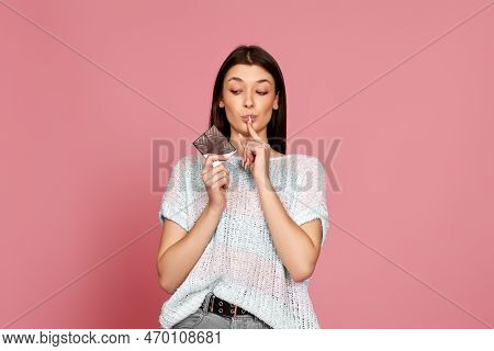 Young Woman In Sweater Holding Chocolate Bar