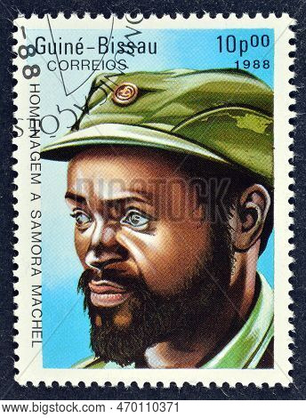 Cancelled Postage Stamp Printed By Guinea Bissau, That Shows Samora Machel (1933-1986), President Of