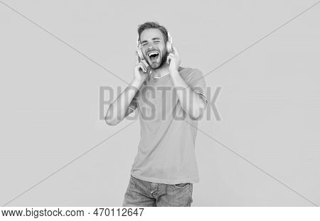 Cheerful Man In Blue Shirt Wear Earphones On Yellow Background, Lifestyle