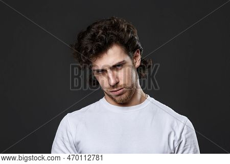Young Upset Curly Man In White T-shirt
