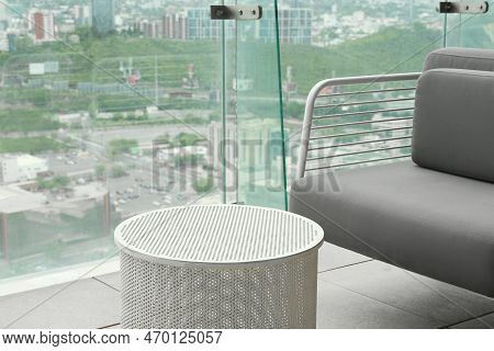Coffee Table And Sofa Against Picturesque Landscape Of City In Cafe