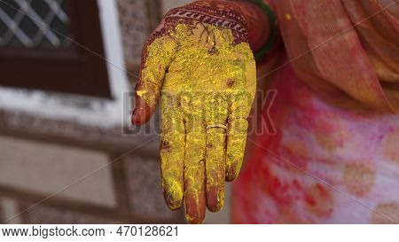 Holi, Festival Of Color, A Woman Girl Lady Wearing Bangles Picking Organic Dry Powder Color Or Colou