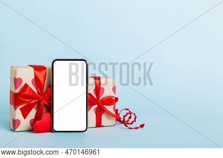Mobile Phone With Blank Screen On Colored Background With Hearts, Calendar And Gift Box, Valentine D