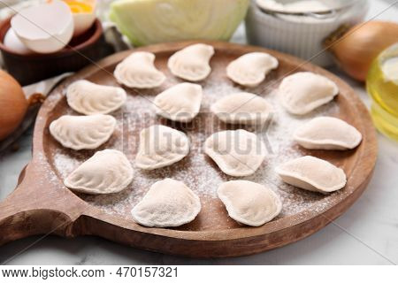 Raw Dumplings (varenyky) With Tasty Filling And Flour On Wooden Board, Closeup