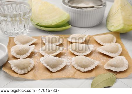 Raw Dumplings (varenyky) With Tasty Filling And Flour On White Tiled Table, Closeup