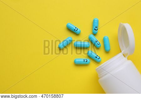 Colorful Antidepressants With Happy Emoticons And Medical Bottle On Yellow Background, Flat Lay. Spa