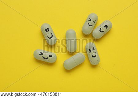 Colorful Antidepressants With Happy Emoticons On Yellow Background, Flat Lay