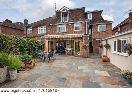 Cambridge, England - June 1 2018: Suburban Landscaped Patio Garden With Open Bifold Doors