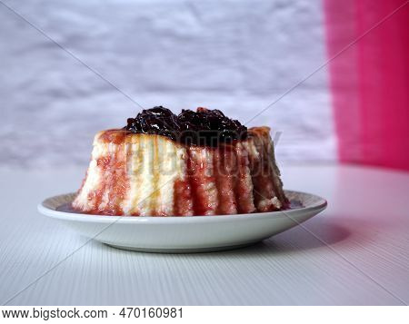 Сheesecake With сherry Jam Or Sauce On A Decorated White Plate. Close Up View.