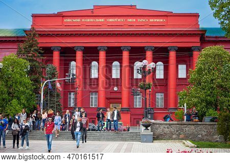 The Red Building Of The Ukrainian Shevchenko University In Kyiv. Students Leave The Main House After